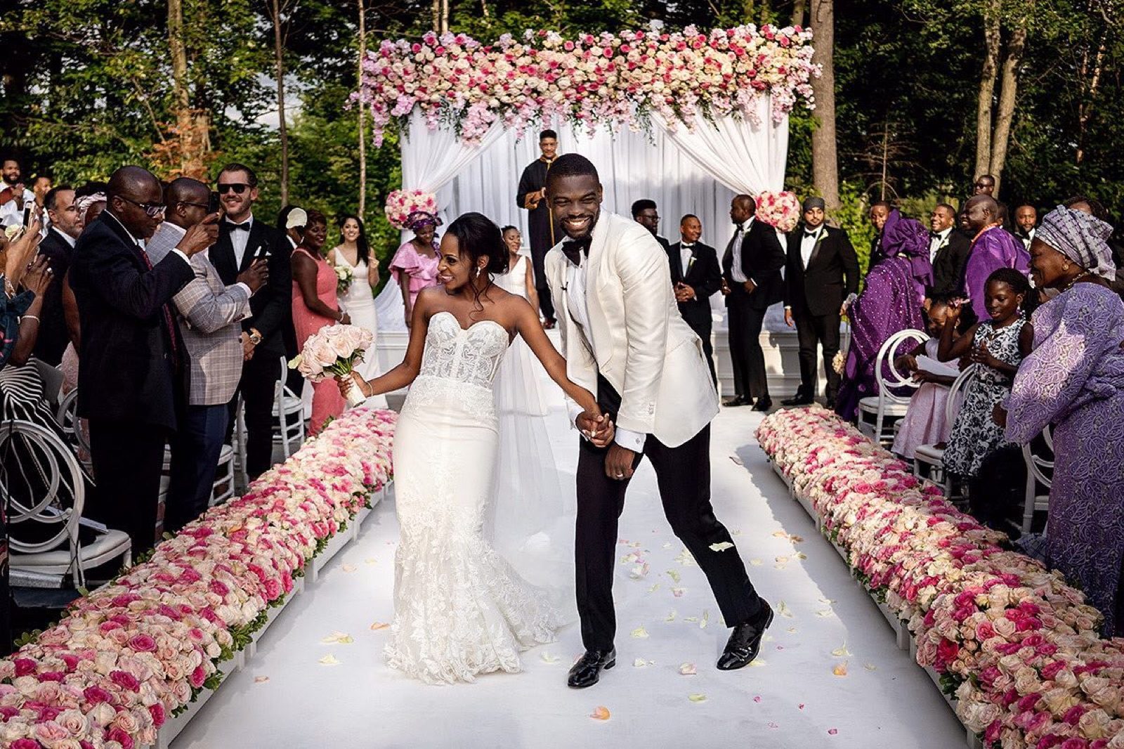 A couple swept down the aisle by applause